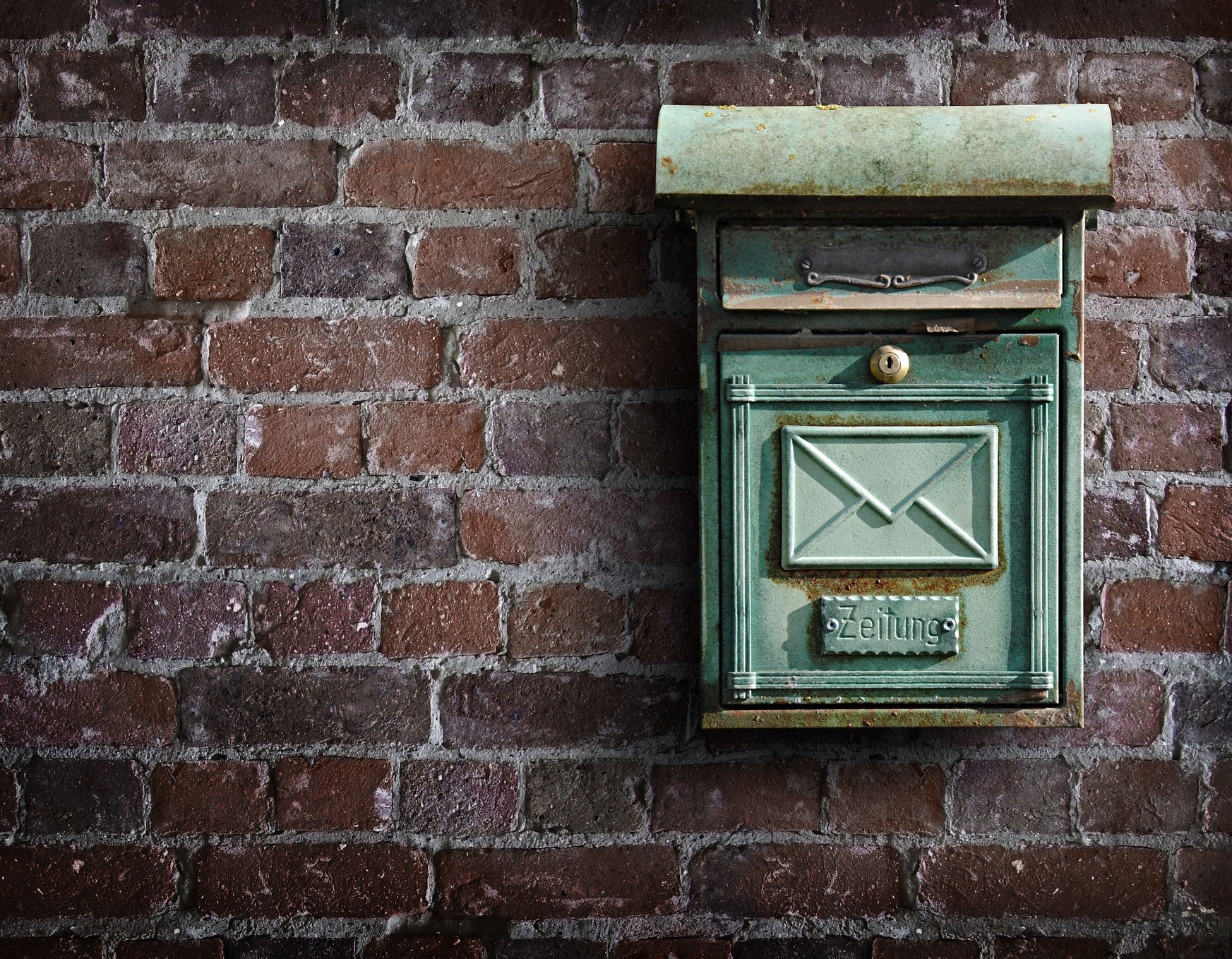 Mailbox attached to brick wall